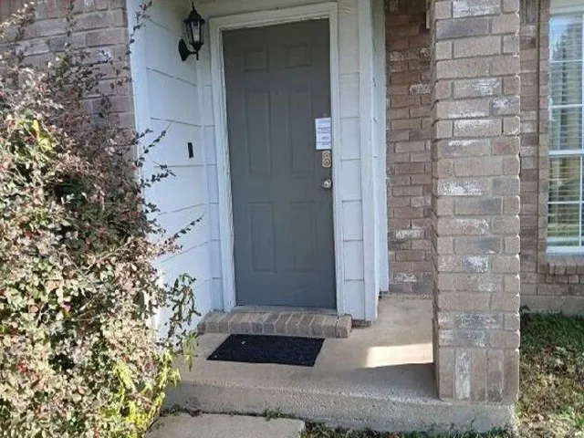 a front view of a house with a garden and yard