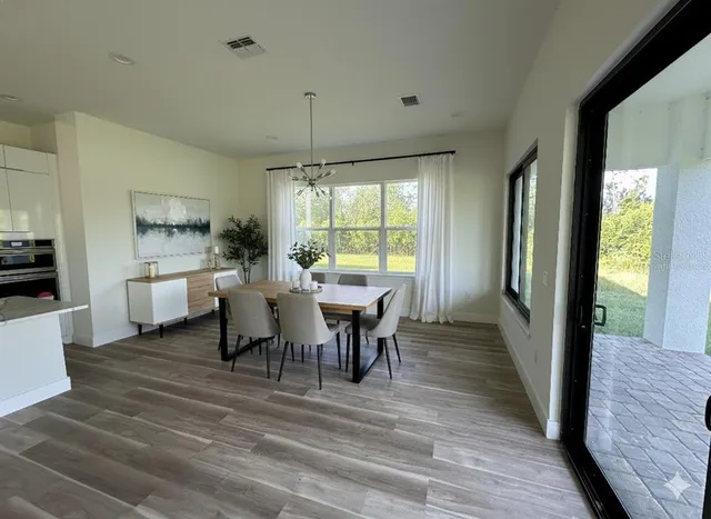 a view of a dining room with furniture window and wooden floor