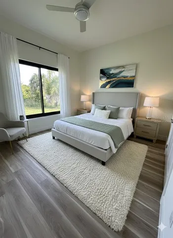 a bedroom with a large bed and a large window