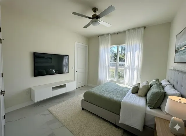 a bedroom with a bed and a television