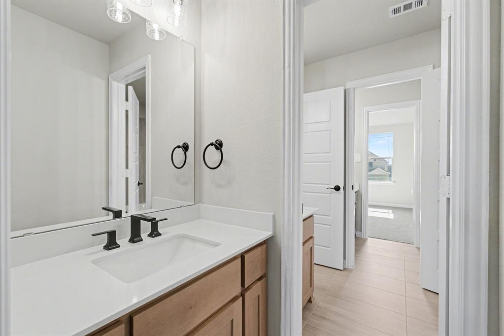 7041 Champion Road Midlothian, TX 76065 - Photo 28 of 30 a bathroom with a sink and a mirror