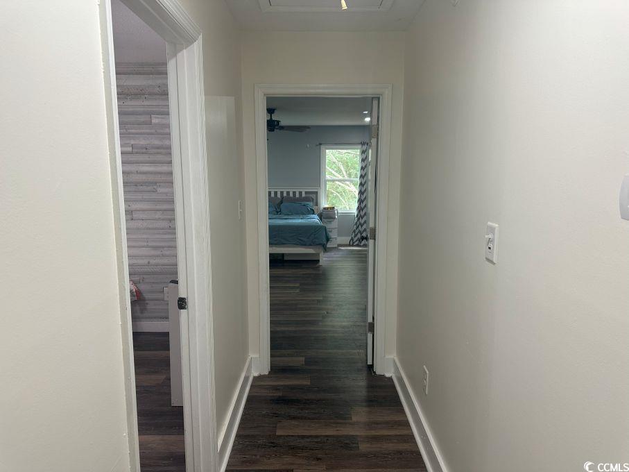 214 Rum Bluff Boulevard Longs, SC 29568 - Photo 18 of 36 Corridor with dark wood finished floors and basebo