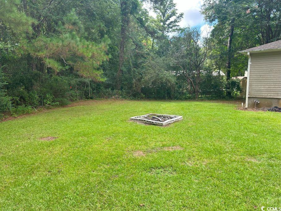 214 Rum Bluff Boulevard Longs, SC 29568 - Photo 32 of 36 View of grassy yard with an outdoor fire pit