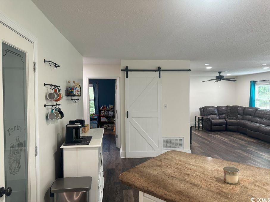 214 Rum Bluff Boulevard Longs, SC 29568 - Photo 9 of 36 Dining room with a barn door, a textured ceiling,