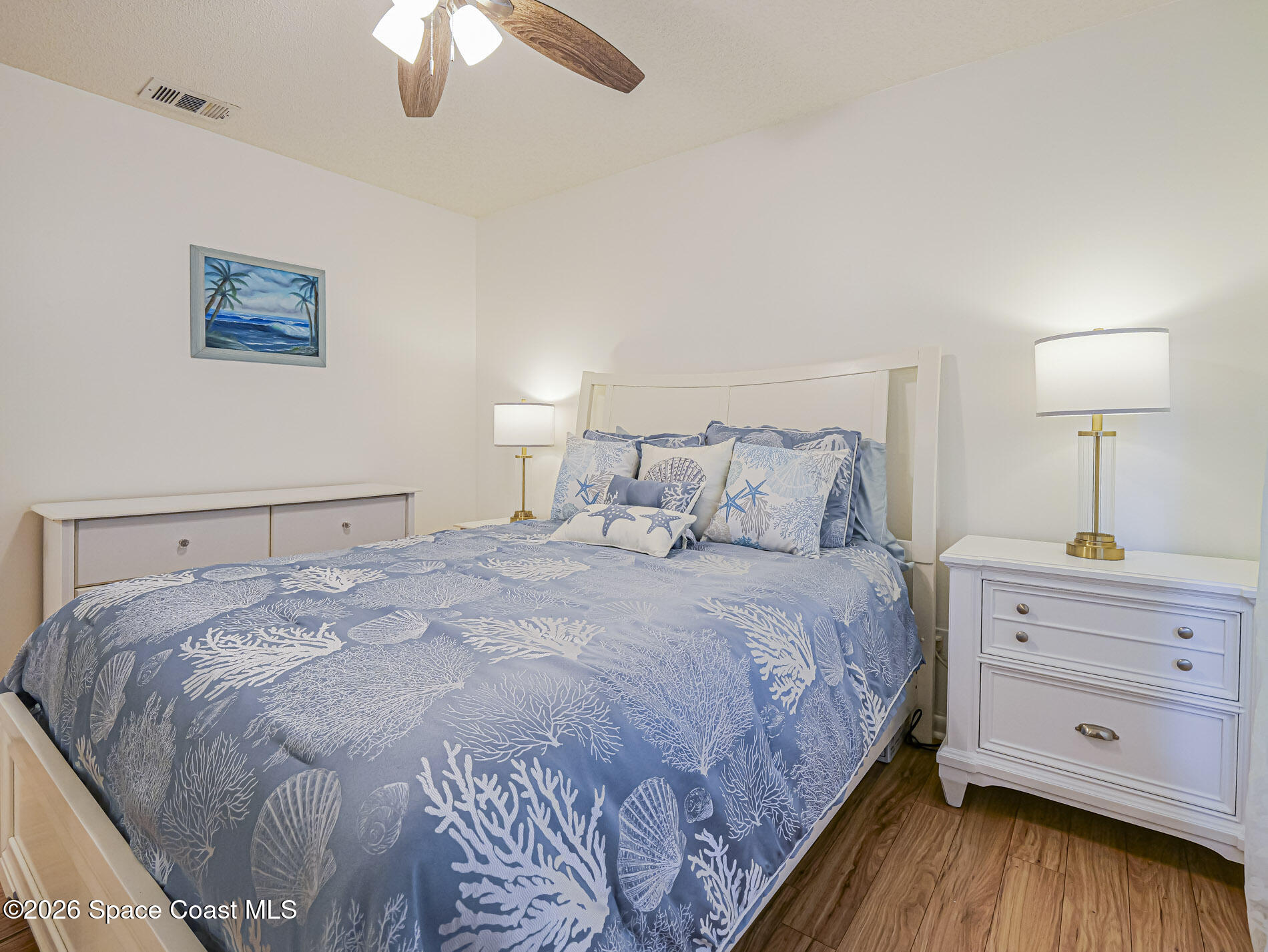 1198 Breezy Way, Unit 7 Sebastian, FL 32958 - Photo 11 of 34 a bedroom with a bed and a chandelier