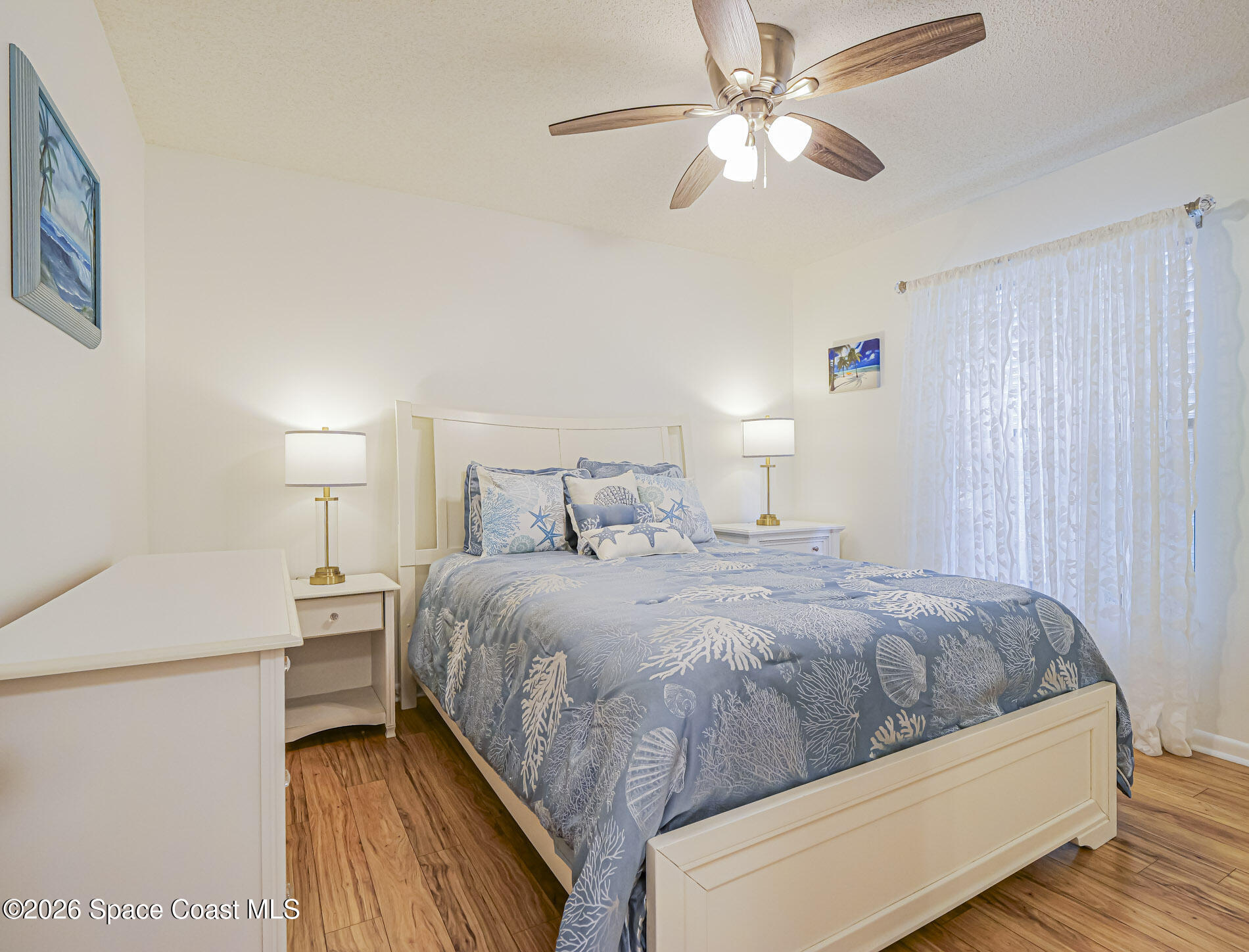 1198 Breezy Way, Unit 7 Sebastian, FL 32958 - Photo 12 of 34 a bedroom with a bed and a ceiling fan