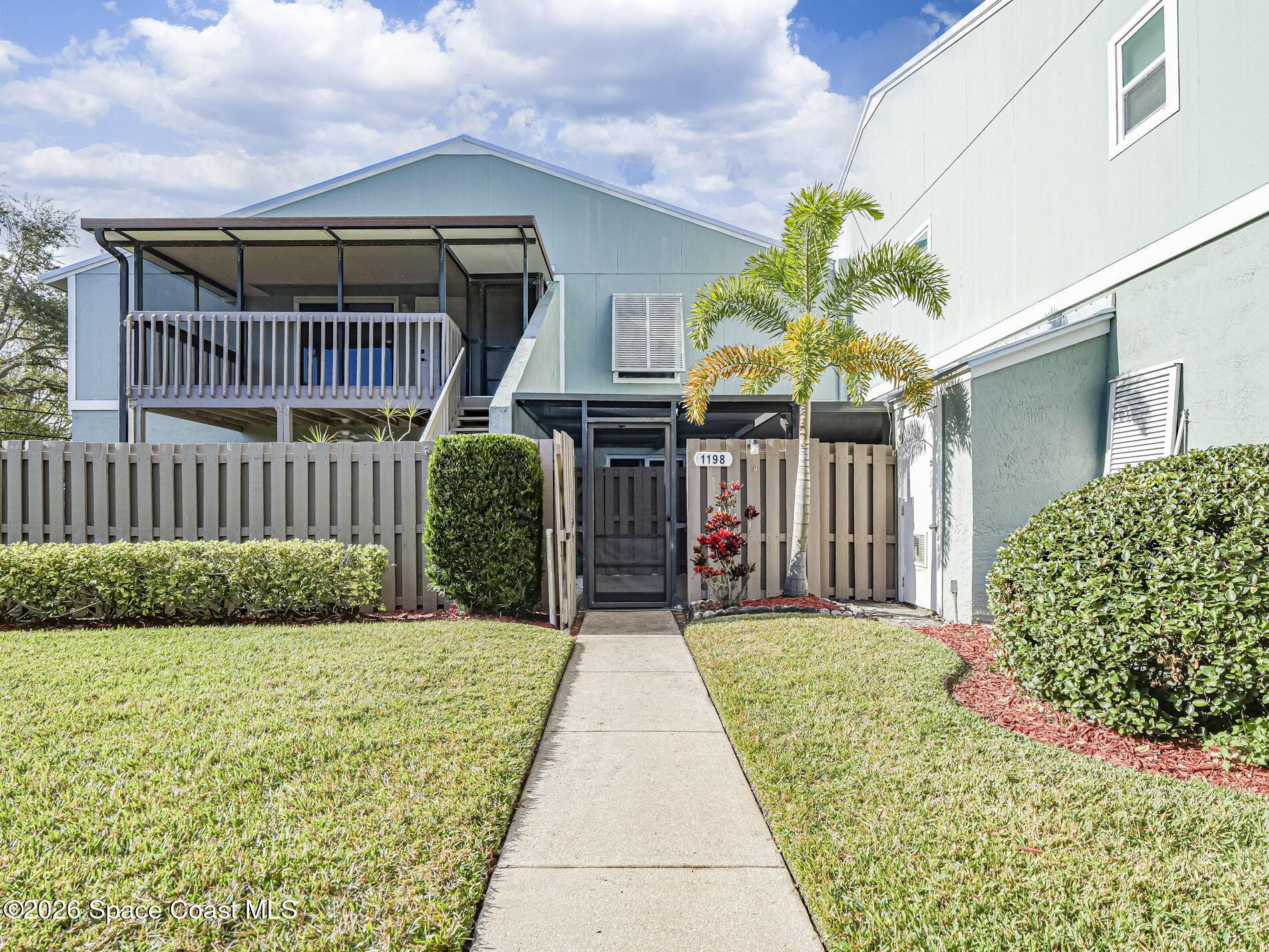 1198 Breezy Way, Unit 7 Sebastian, FL 32958 - Photo 2 of 34 a front view of a house with garden