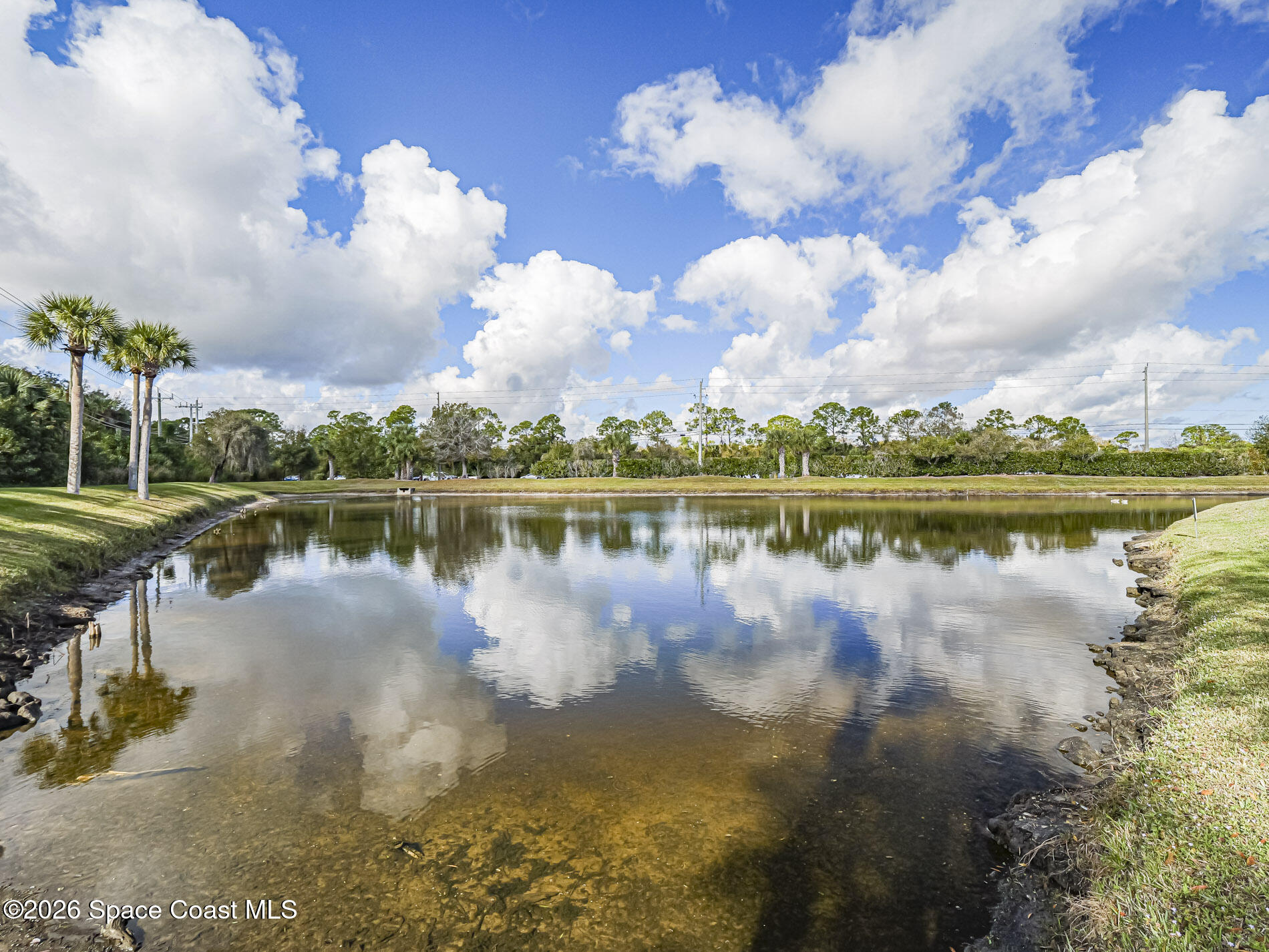 1198 Breezy Way, Unit 7 Sebastian, FL 32958 - Photo 22 of 34 a view of a lake with houses in the back