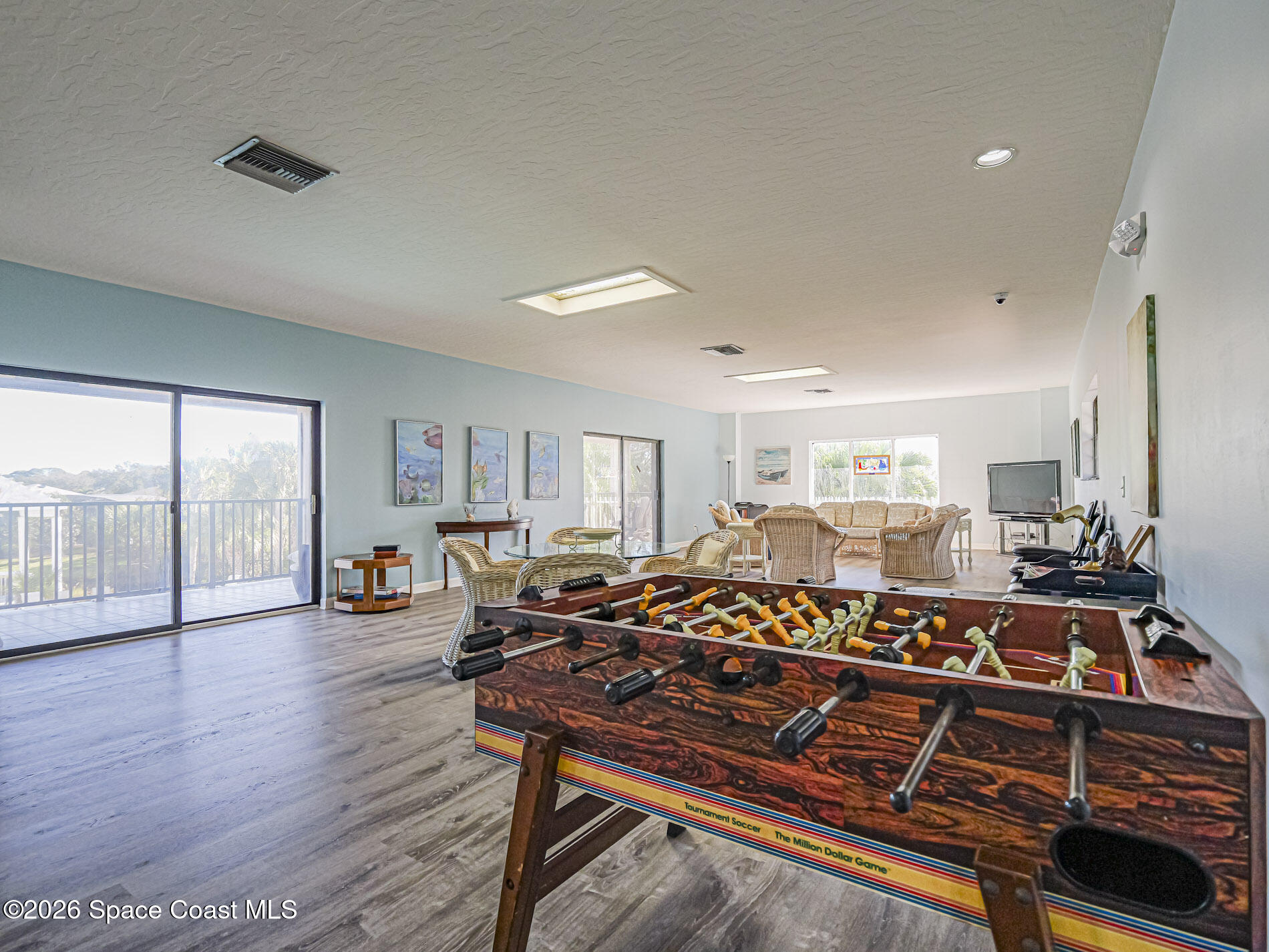1198 Breezy Way, Unit 7 Sebastian, FL 32958 - Photo 28 of 34 a living room with lots of furniture wooden floor and a rug