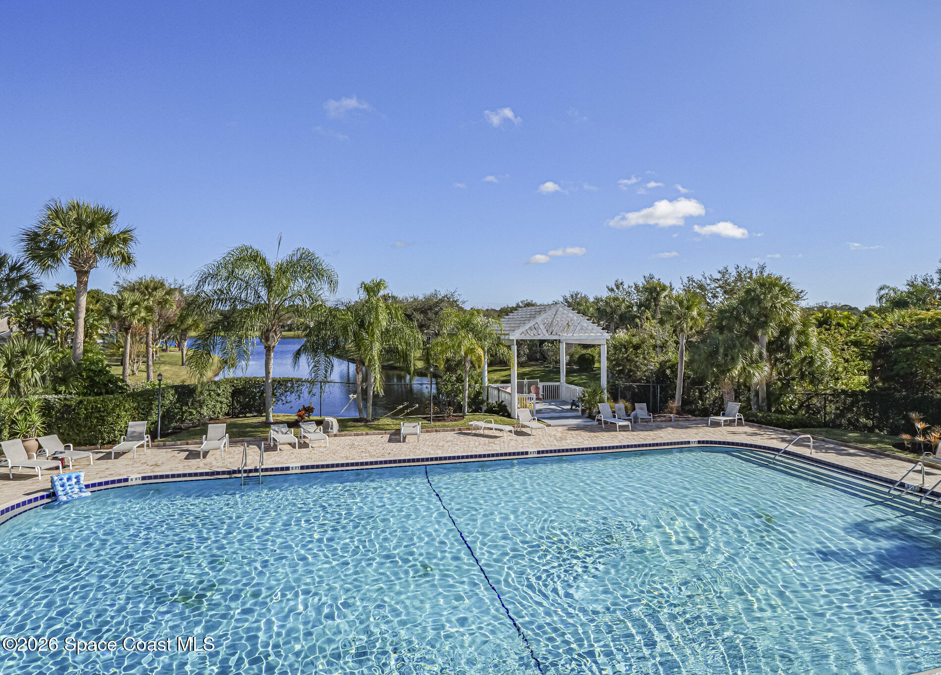 1198 Breezy Way, Unit 7 Sebastian, FL 32958 - Photo 30 of 34 a view of a swimming pool and lounge chairs