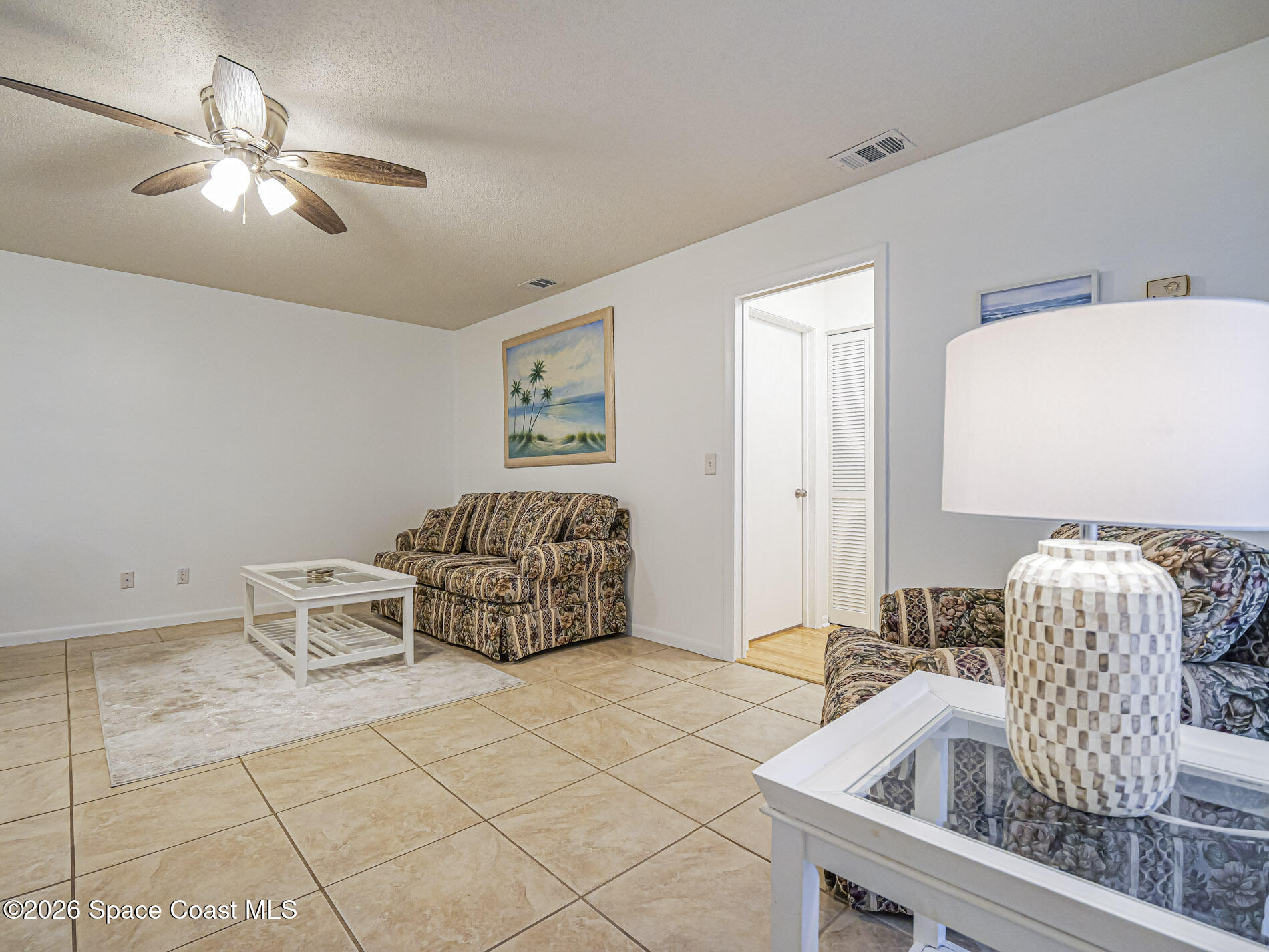 1198 Breezy Way, Unit 7 Sebastian, FL 32958 - Photo 6 of 34 a living room with furniture and a chandelier