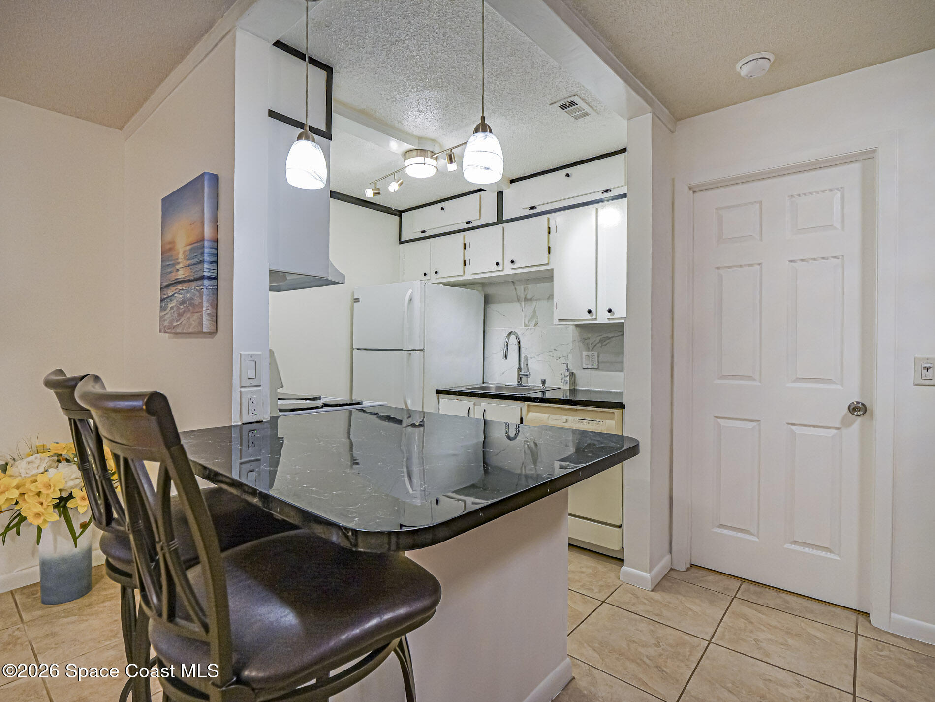 1198 Breezy Way, Unit 7 Sebastian, FL 32958 - Photo 7 of 34 a kitchen with a dining table and chairs
