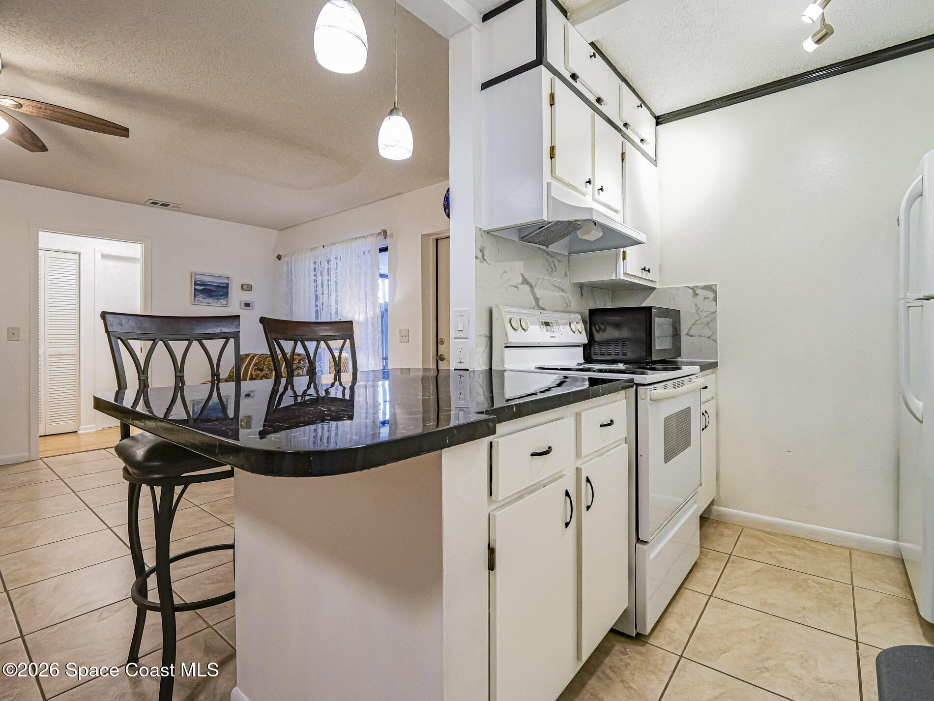1198 Breezy Way, Unit 7 Sebastian, FL 32958 - Photo 8 of 34 a kitchen with stainless steel appliances a white refrigerator oven a sink and dishwasher