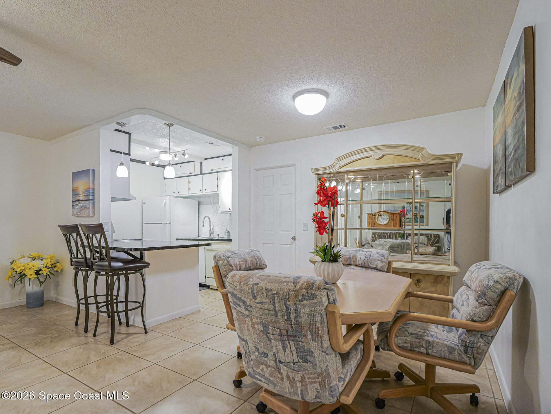 1198 Breezy Way, Unit 7 Sebastian, FL 32958 - Photo 9 of 34 a dining room with furniture a chandelier and window