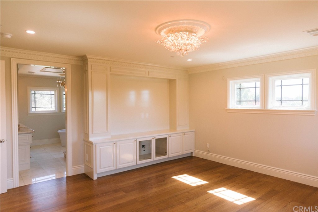 1122 Drake Road Arcadia, CA 91007 - Photo 15 of 30 a view of an empty room with wooden floor and a window