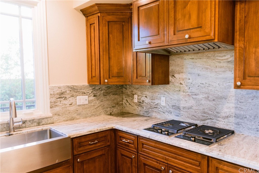 1122 Drake Road Arcadia, CA 91007 - Photo 26 of 30 a kitchen with granite countertop a sink stove and cabinets