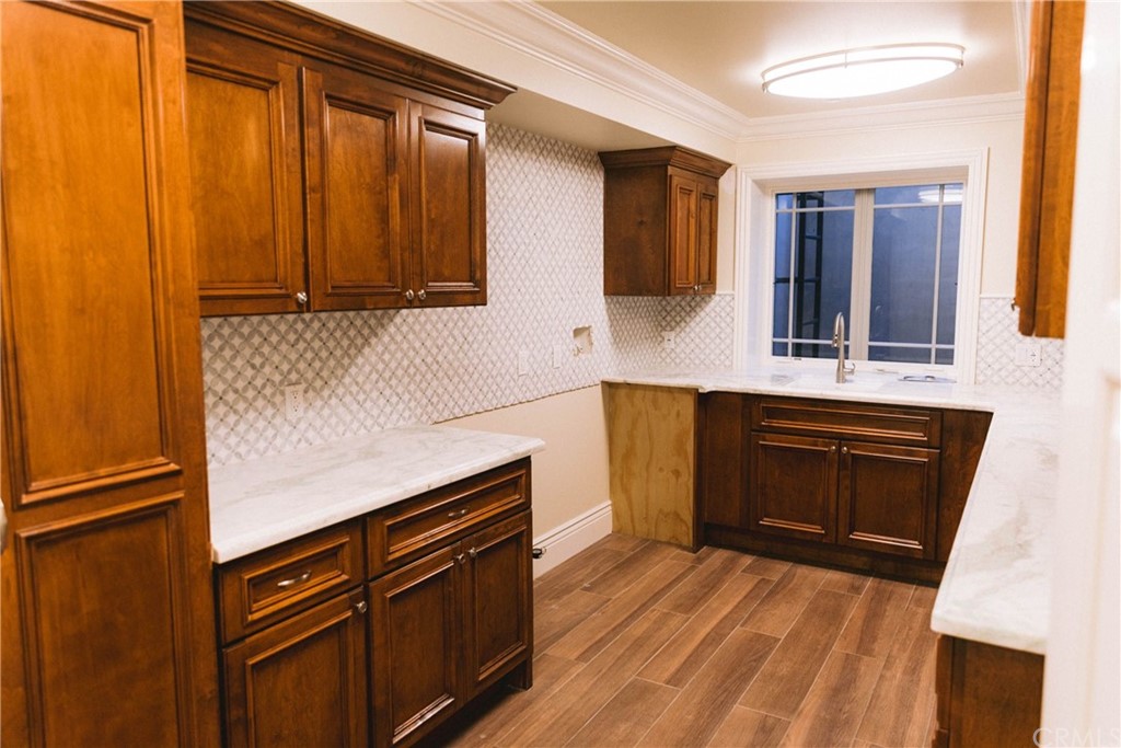 1122 Drake Road Arcadia, CA 91007 - Photo 27 of 30 a kitchen with granite countertop wooden cabinets and a stove top oven