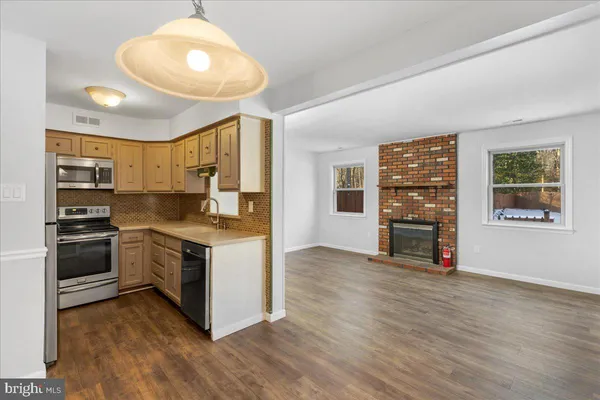 a kitchen with stainless steel appliances granite countertop a stove and a refrigerator