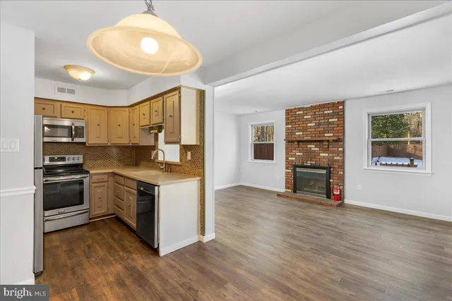 a kitchen with stainless steel appliances granite countertop a stove and a refrigerator