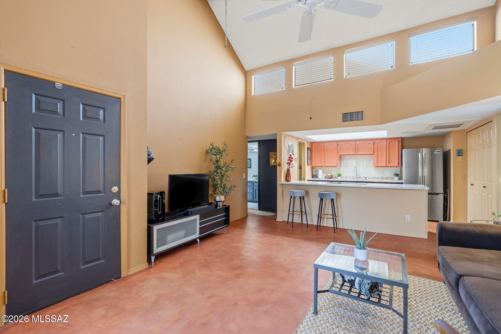 1200 East River Road, Unit G87 Tucson, AZ 85718 - Photo 9 of 30 a living room with furniture and a flat screen tv
