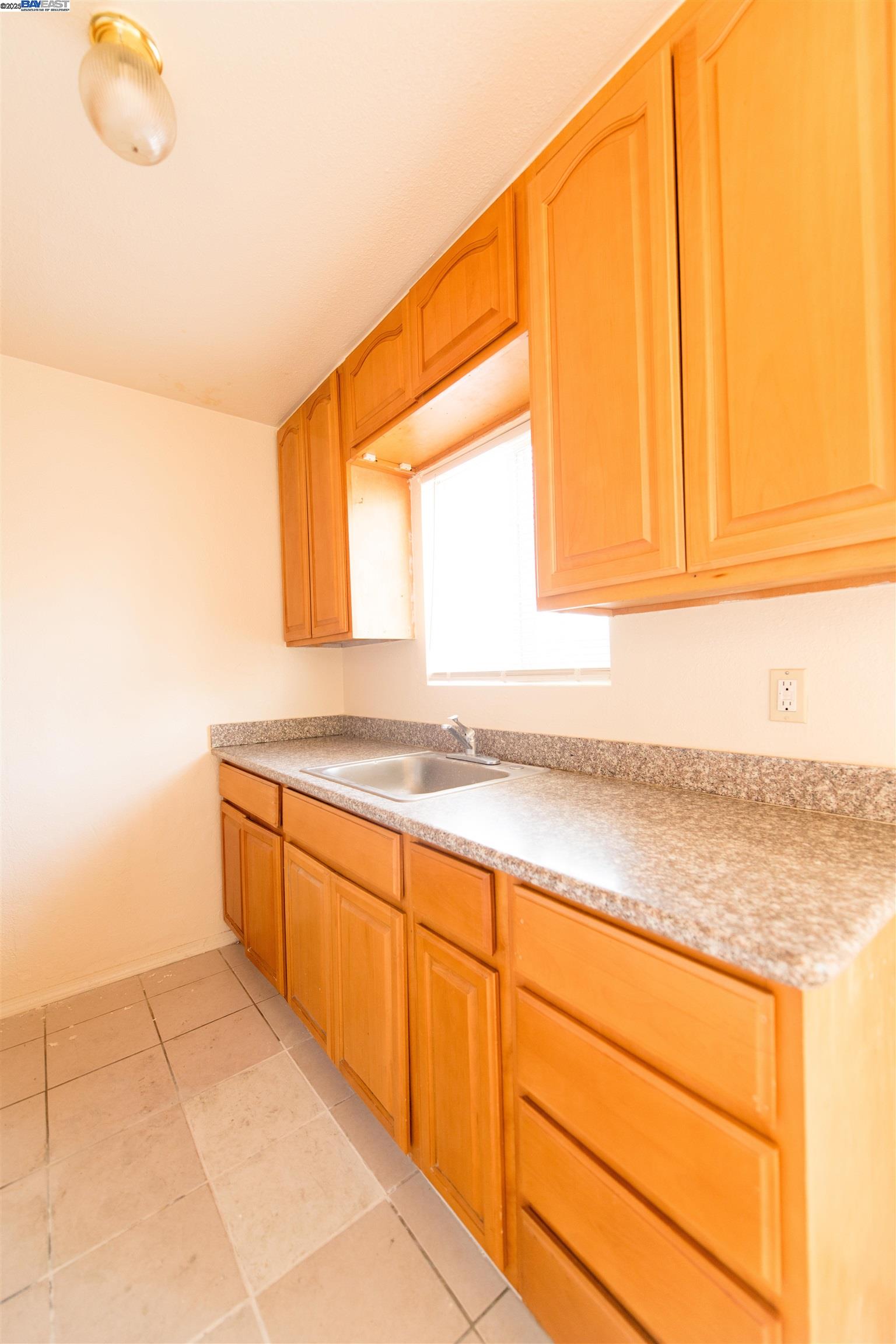 731 Calvados Avenue, Unit B Sacramento, CA 95815 - Photo 3 of 7 a view of a kitchen with wooden floor and cabinets