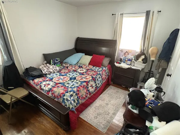 a bed sitting in a bedroom next to a window