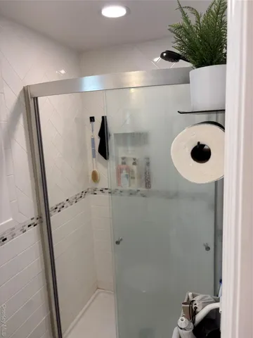 a bathroom with a shower and a sink