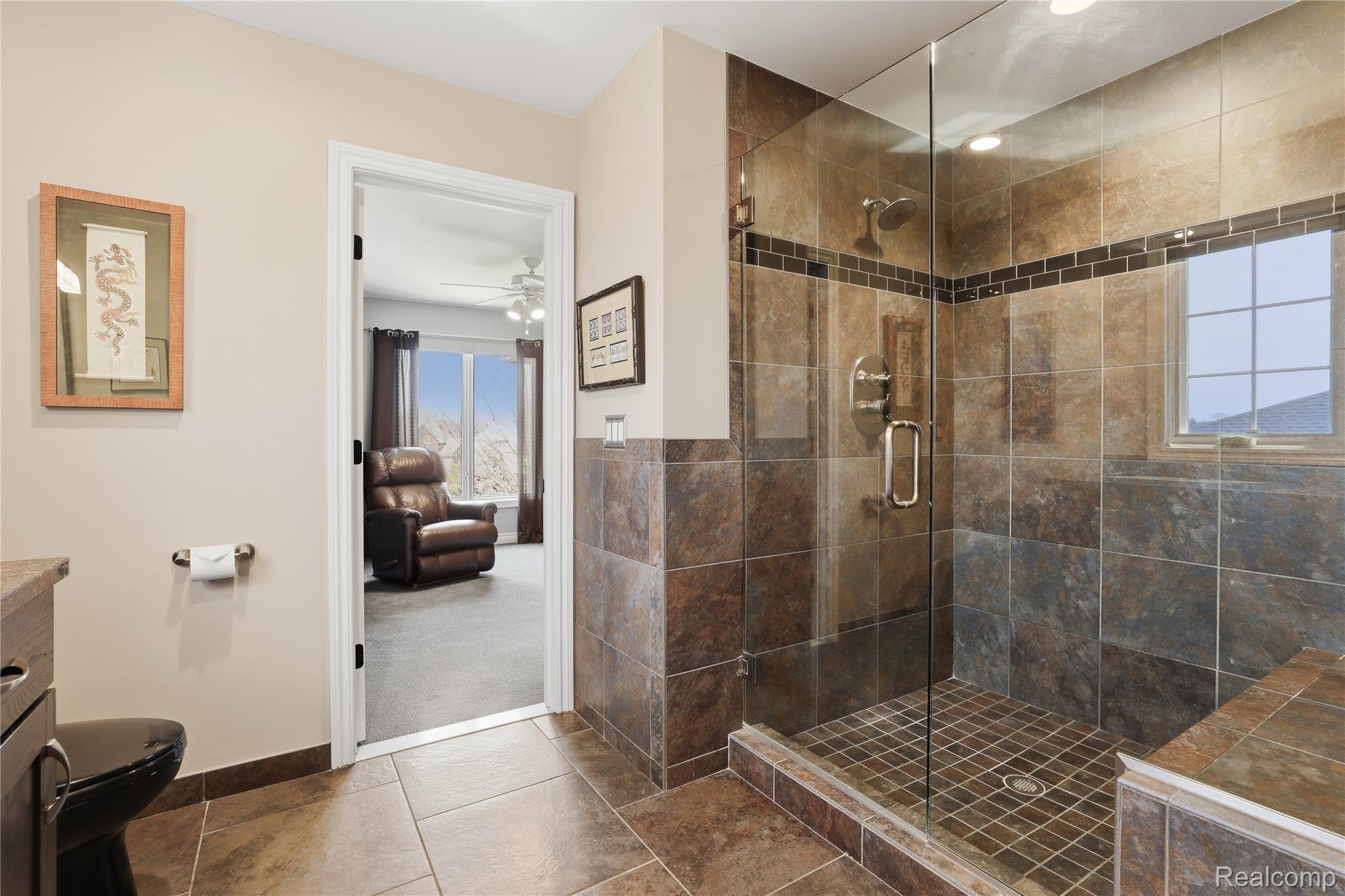 668 Springview Drive Rochester, MI 48307 - Photo 55 of 90 Bathroom with a stall shower, vanity, a ceiling fan, tile patterned flooring, and ensuite bath