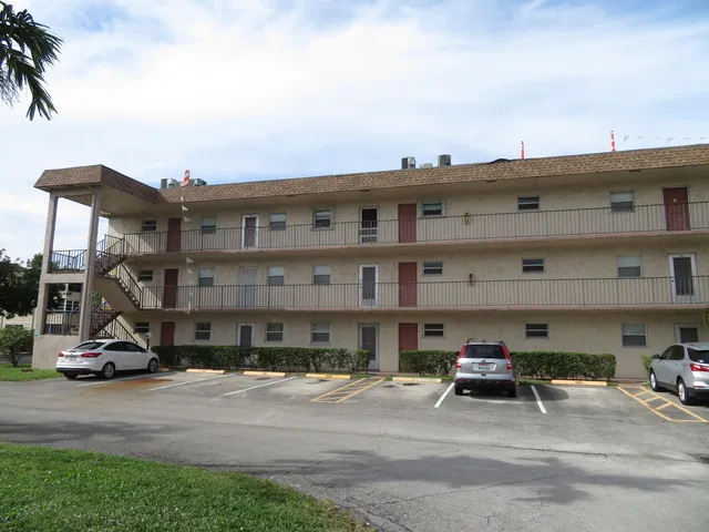 a view of a building with a sink and potted plants