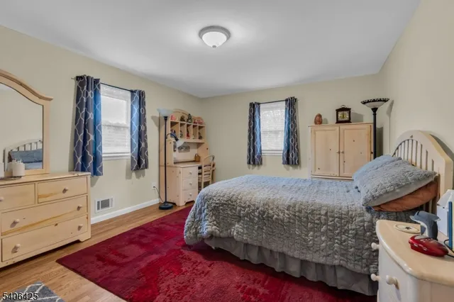 a bedroom with a bed and a dresser in it