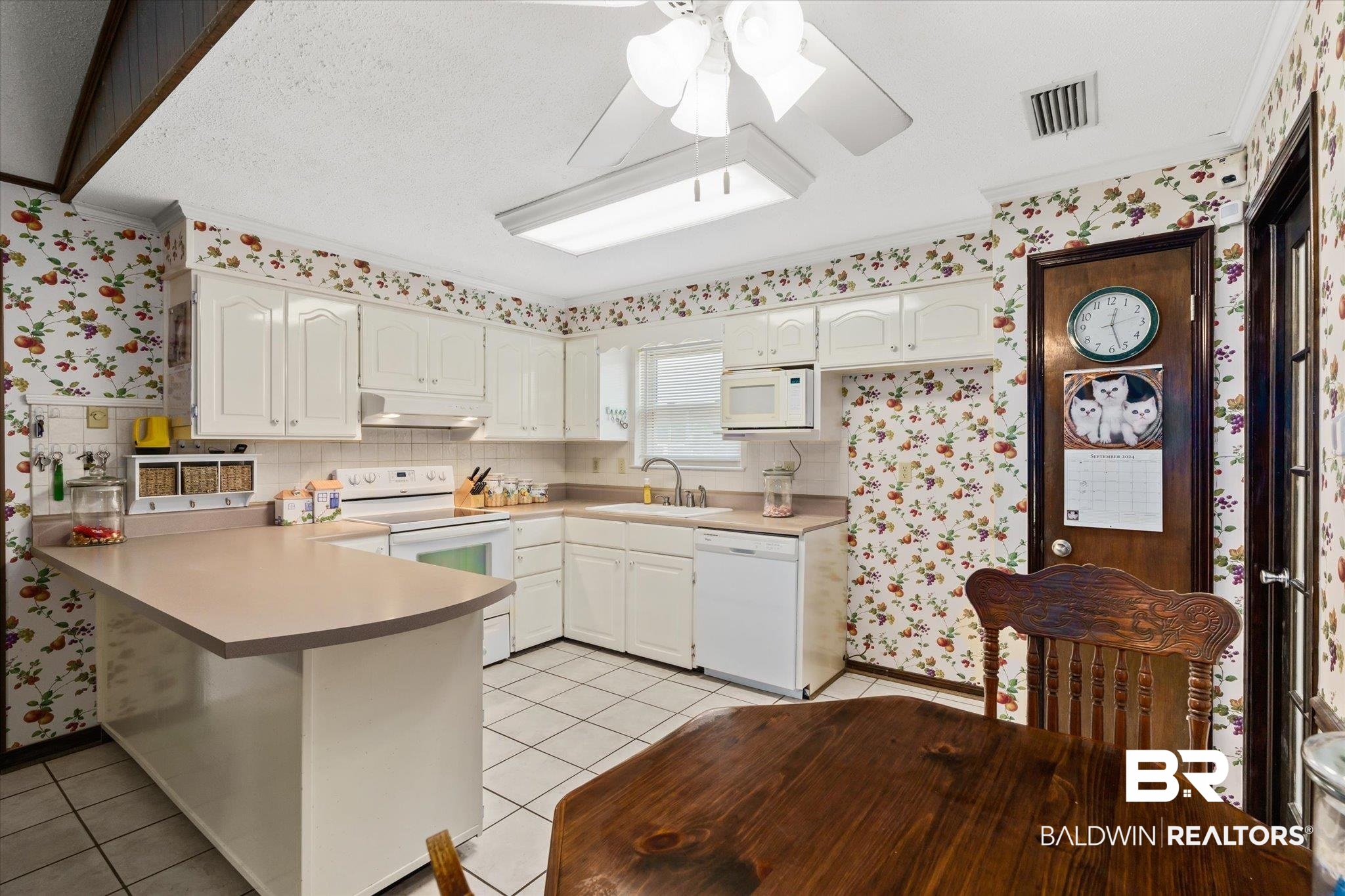 1604 Celeste Road Saraland, AL 36571 - Photo 12 of 31 Kitchen with a skylight, white appliances, sink, kitchen peninsula, and ceiling fan