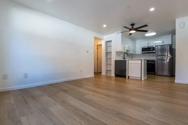 a view of a kitchen with a sink and a refrigerator