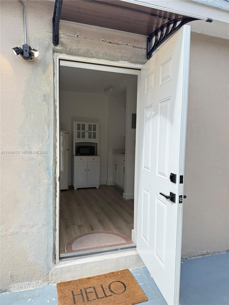 541 East 38th Street, Unit E Hialeah, FL 33013 - Photo 11 of 11 a view of a hallway with wooden floor and a cabinet