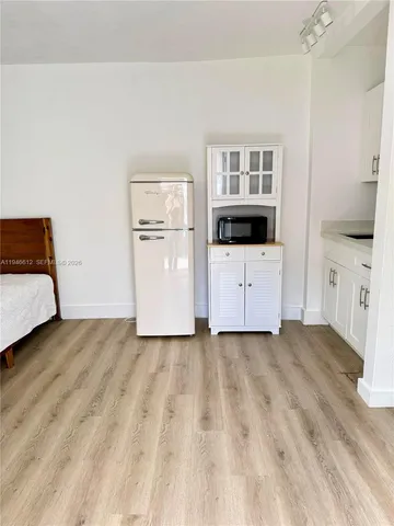 a view of a room with a cabinet and mirror