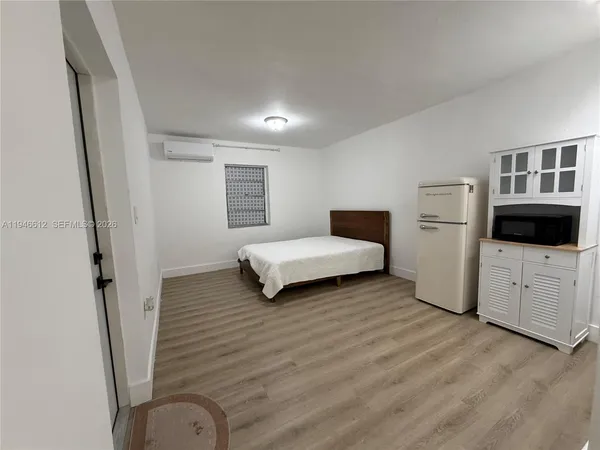 a bedroom with a bed and a couch