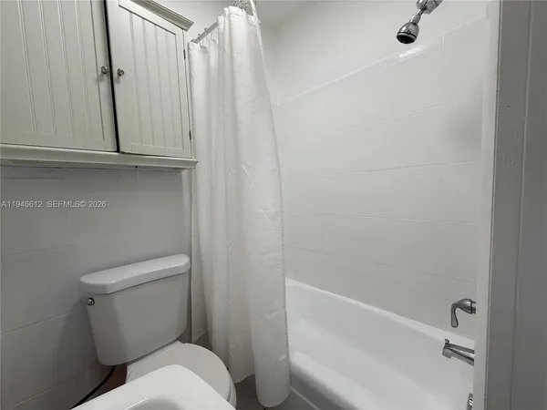 a bathroom with a toilet and tub