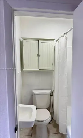 a white toilet sitting next to a bathroom sink