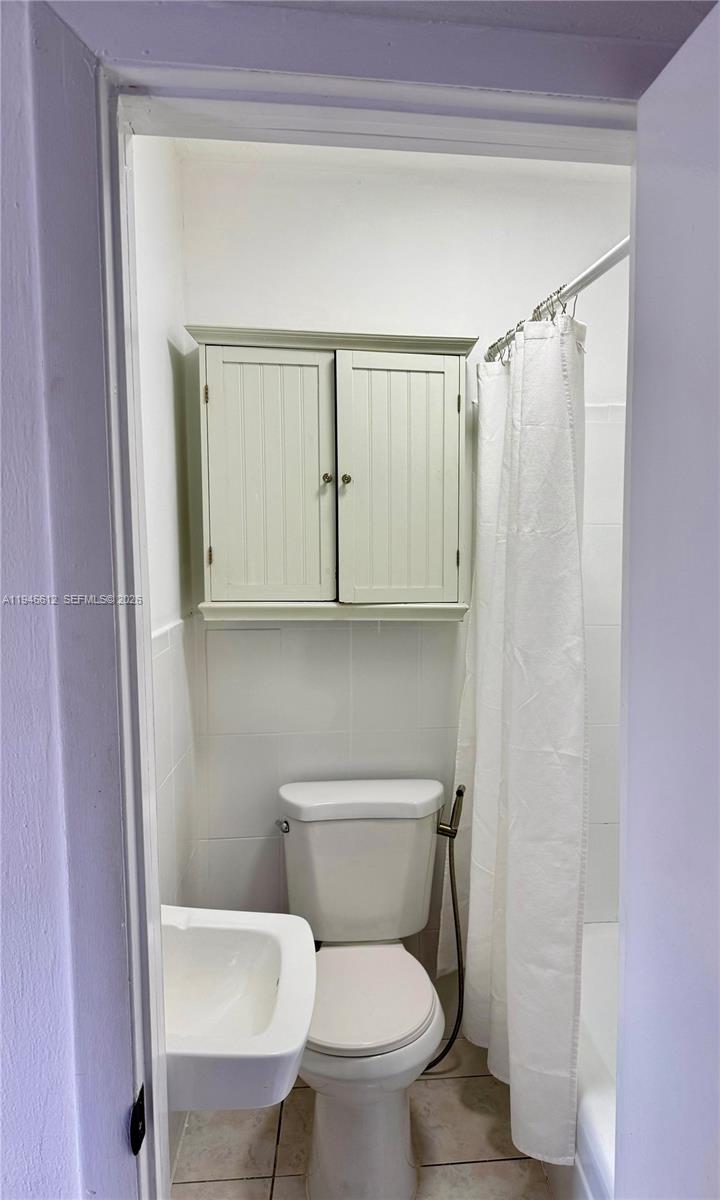 541 East 38th Street, Unit E Hialeah, FL 33013 - Photo 8 of 11 a white toilet sitting next to a bathroom sink
