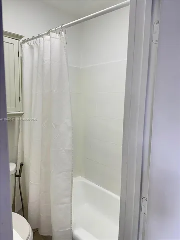 a bathroom with a shower and a toilet