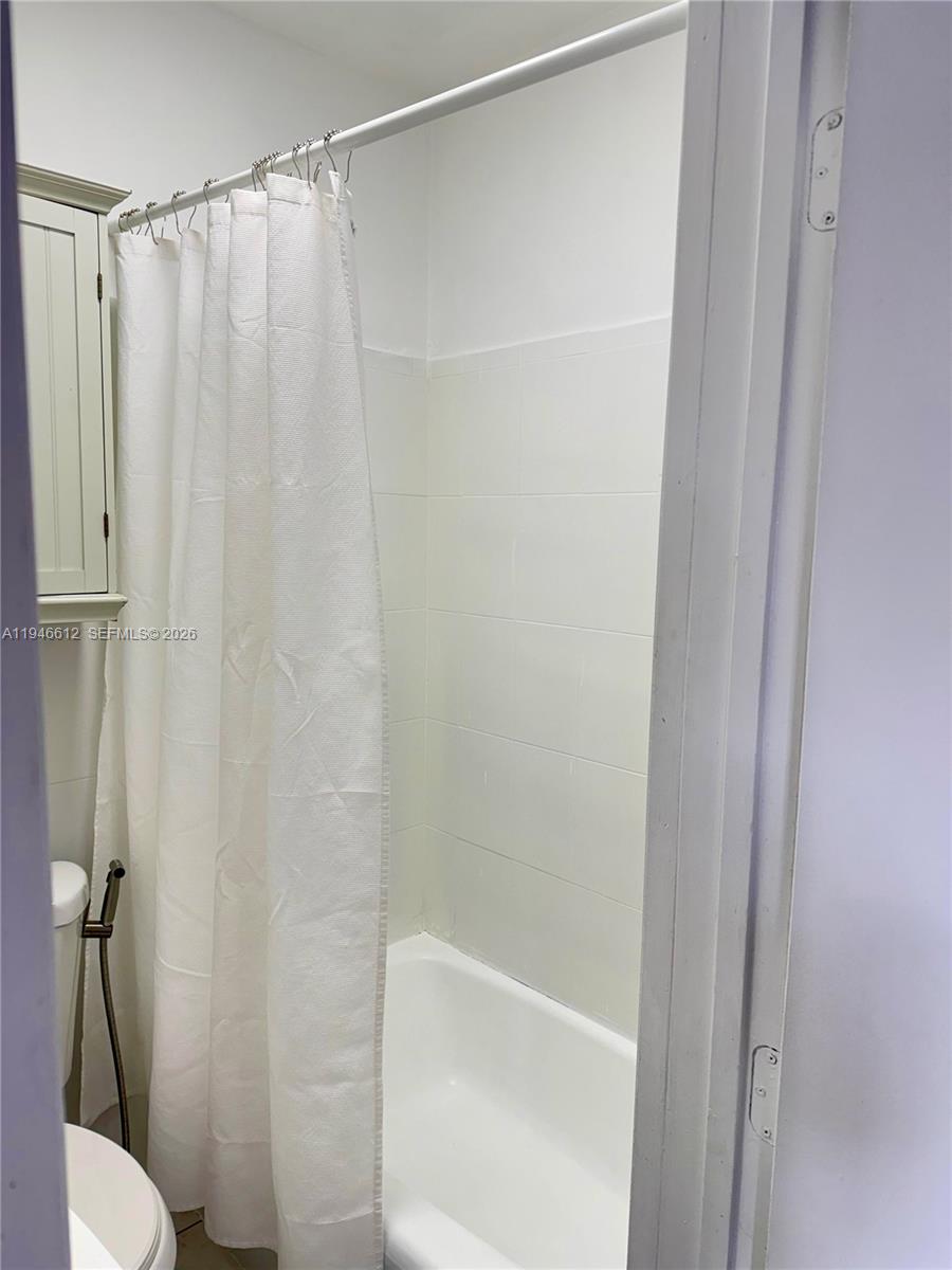 541 East 38th Street, Unit E Hialeah, FL 33013 - Photo 9 of 11 a bathroom with a shower and a toilet