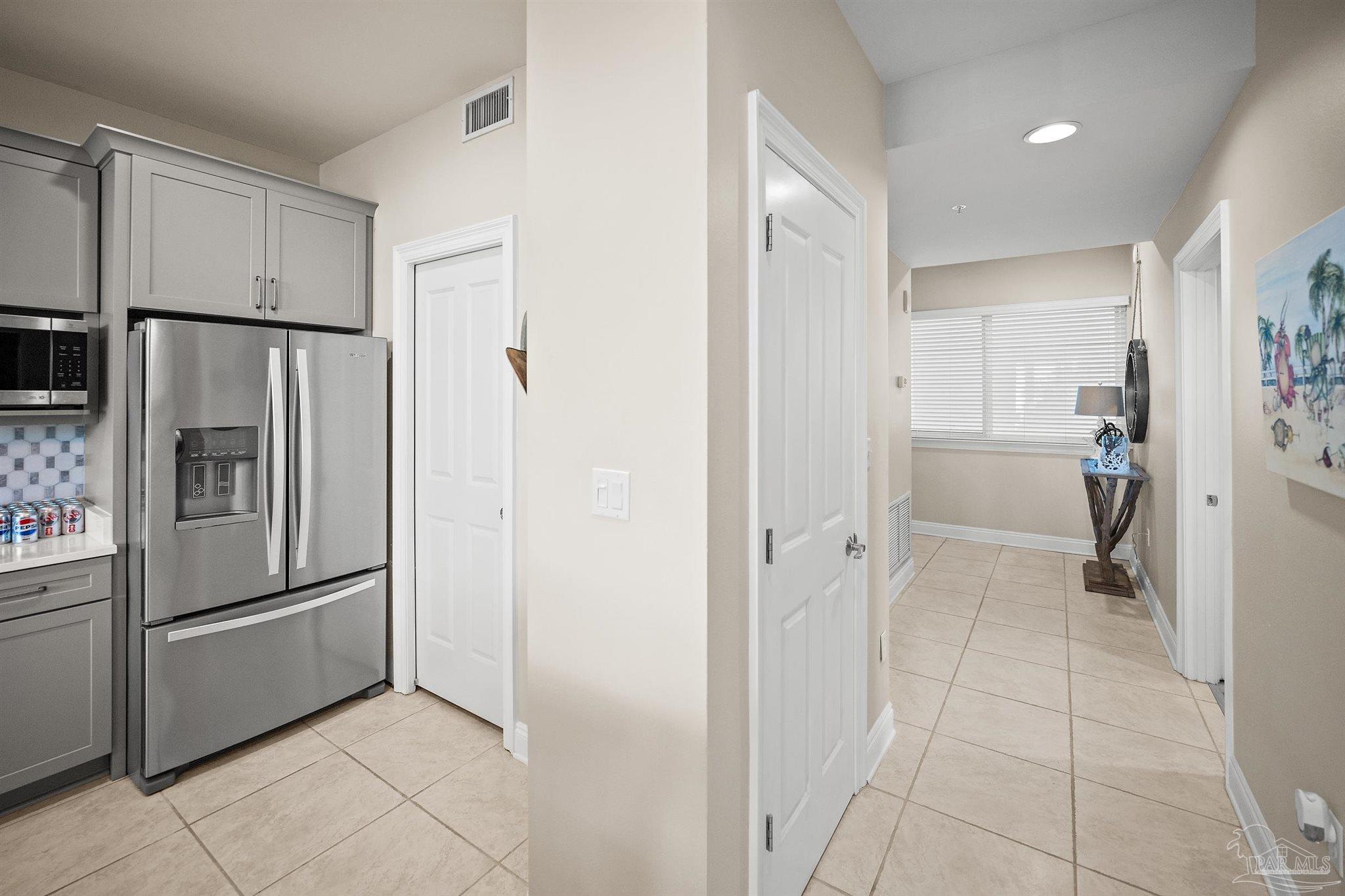 28250 Canal Road, Unit 205 Orange Beach, AL 36561 - Photo 11 of 60 a kitchen with a refrigerator and a sink