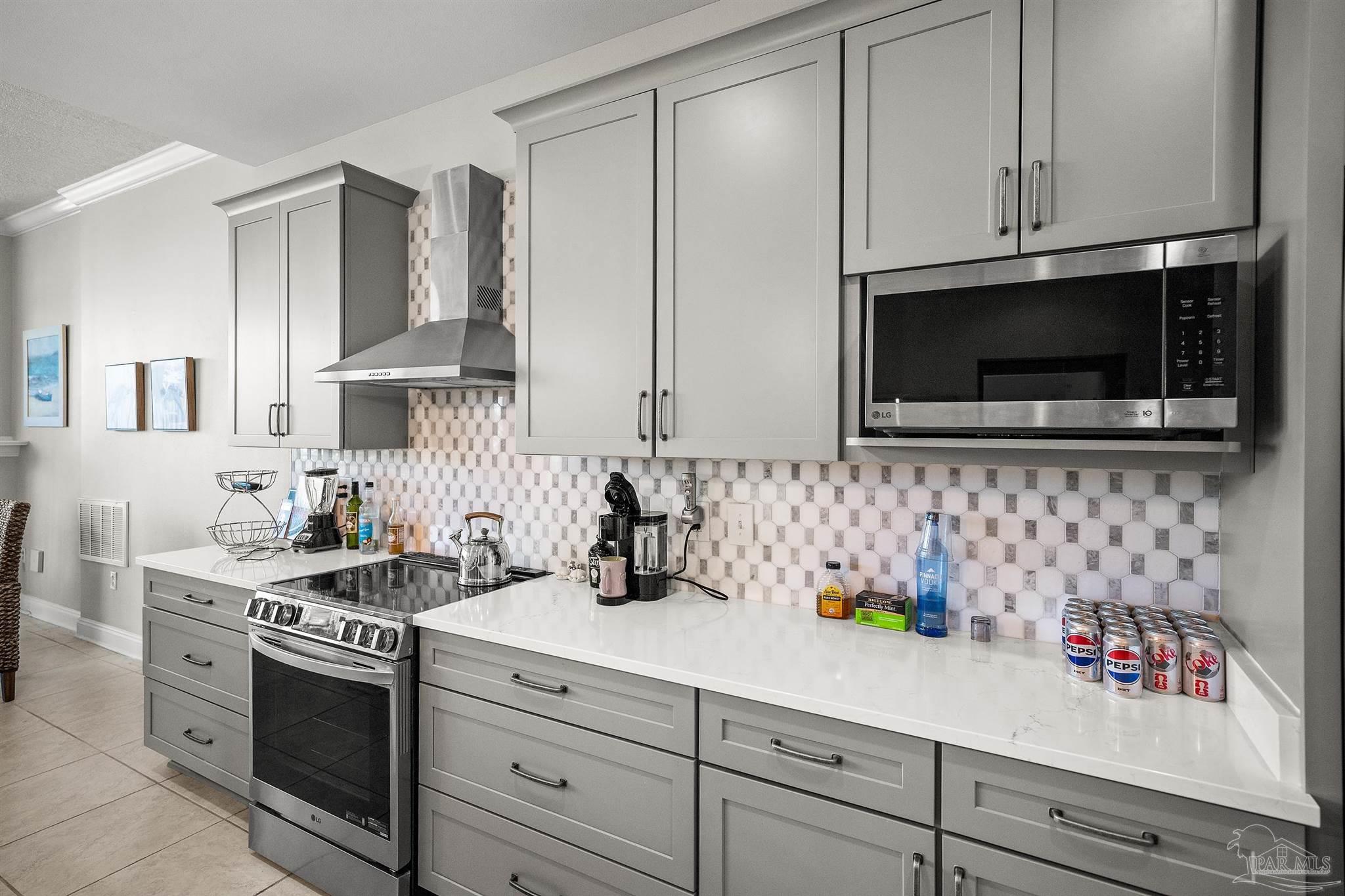 28250 Canal Road, Unit 205 Orange Beach, AL 36561 - Photo 14 of 60 a kitchen with stainless steel appliances white cabinets and a sink
