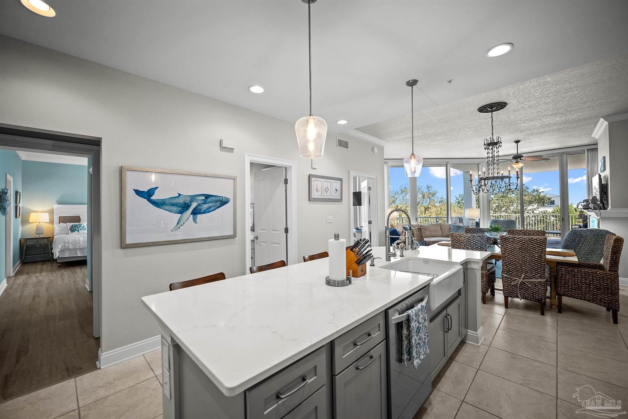 28250 Canal Road, Unit 205 Orange Beach, AL 36561 - Photo 16 of 60 a kitchen with a sink a stove and chairs