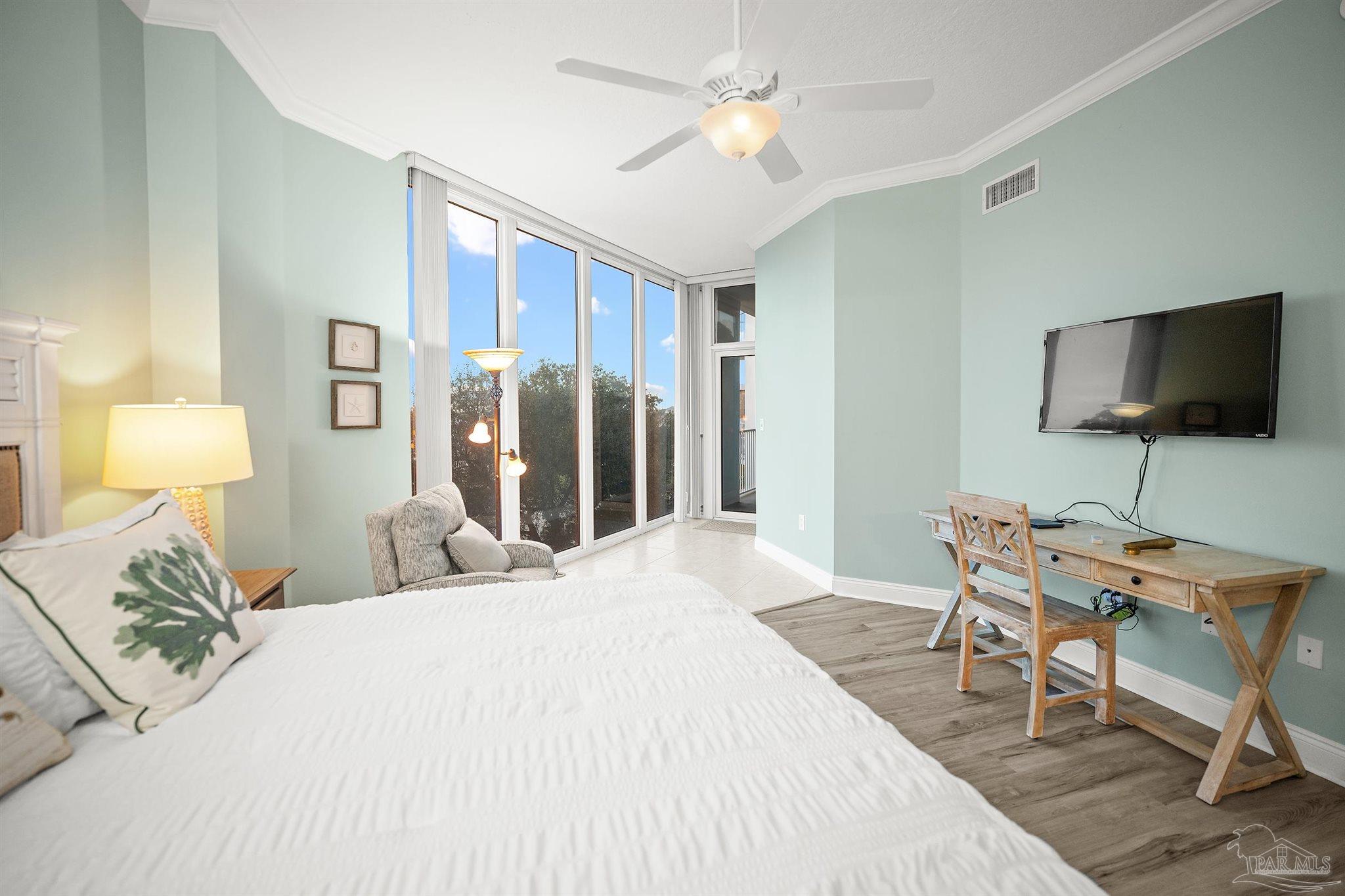 28250 Canal Road, Unit 205 Orange Beach, AL 36561 - Photo 21 of 60 a bedroom with a bed and a flat screen tv