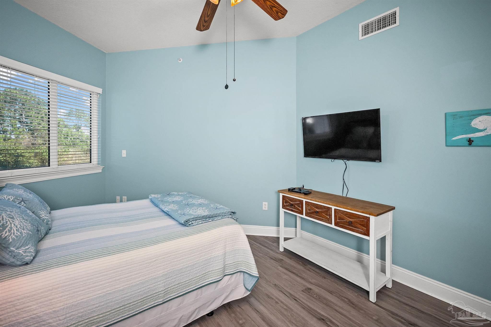 28250 Canal Road, Unit 205 Orange Beach, AL 36561 - Photo 23 of 60 a bedroom with a bed and a flat screen tv