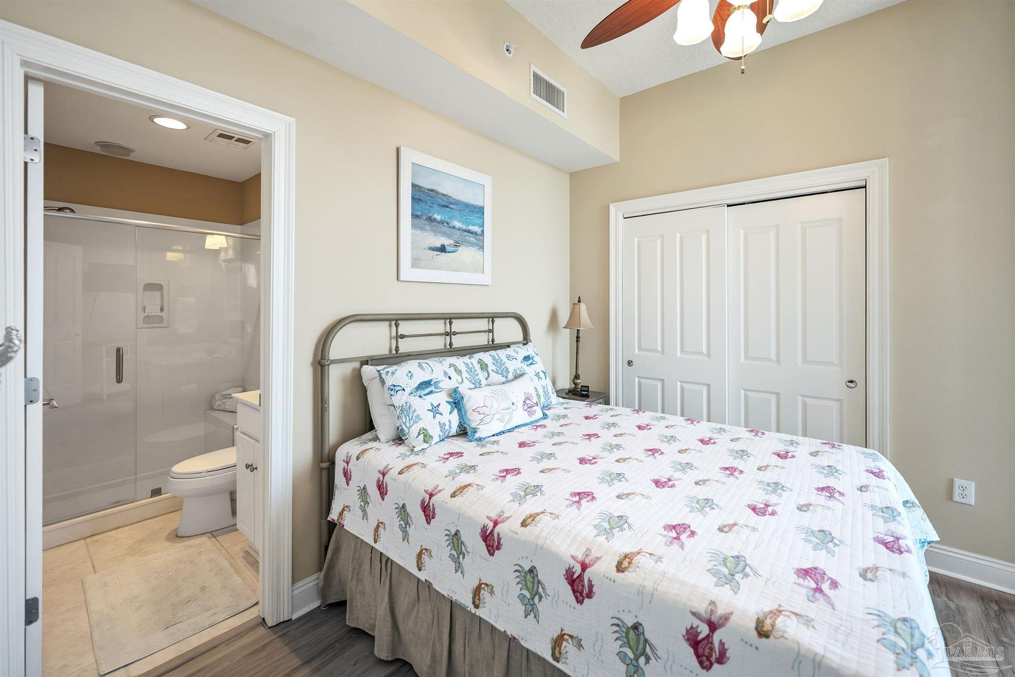28250 Canal Road, Unit 205 Orange Beach, AL 36561 - Photo 25 of 60 a bedroom with a bed and a view of bathroom