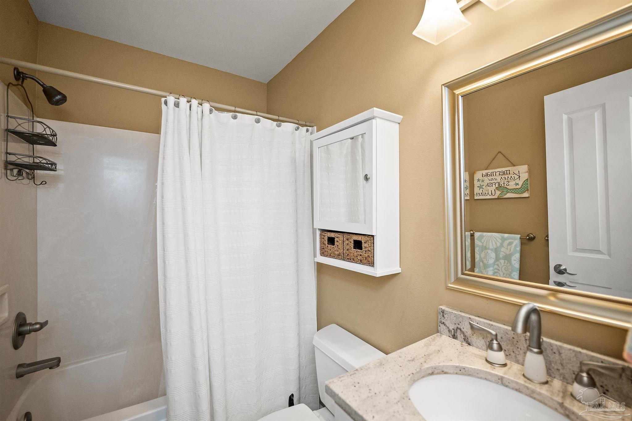 28250 Canal Road, Unit 205 Orange Beach, AL 36561 - Photo 27 of 60 a bathroom with a sink and a mirror
