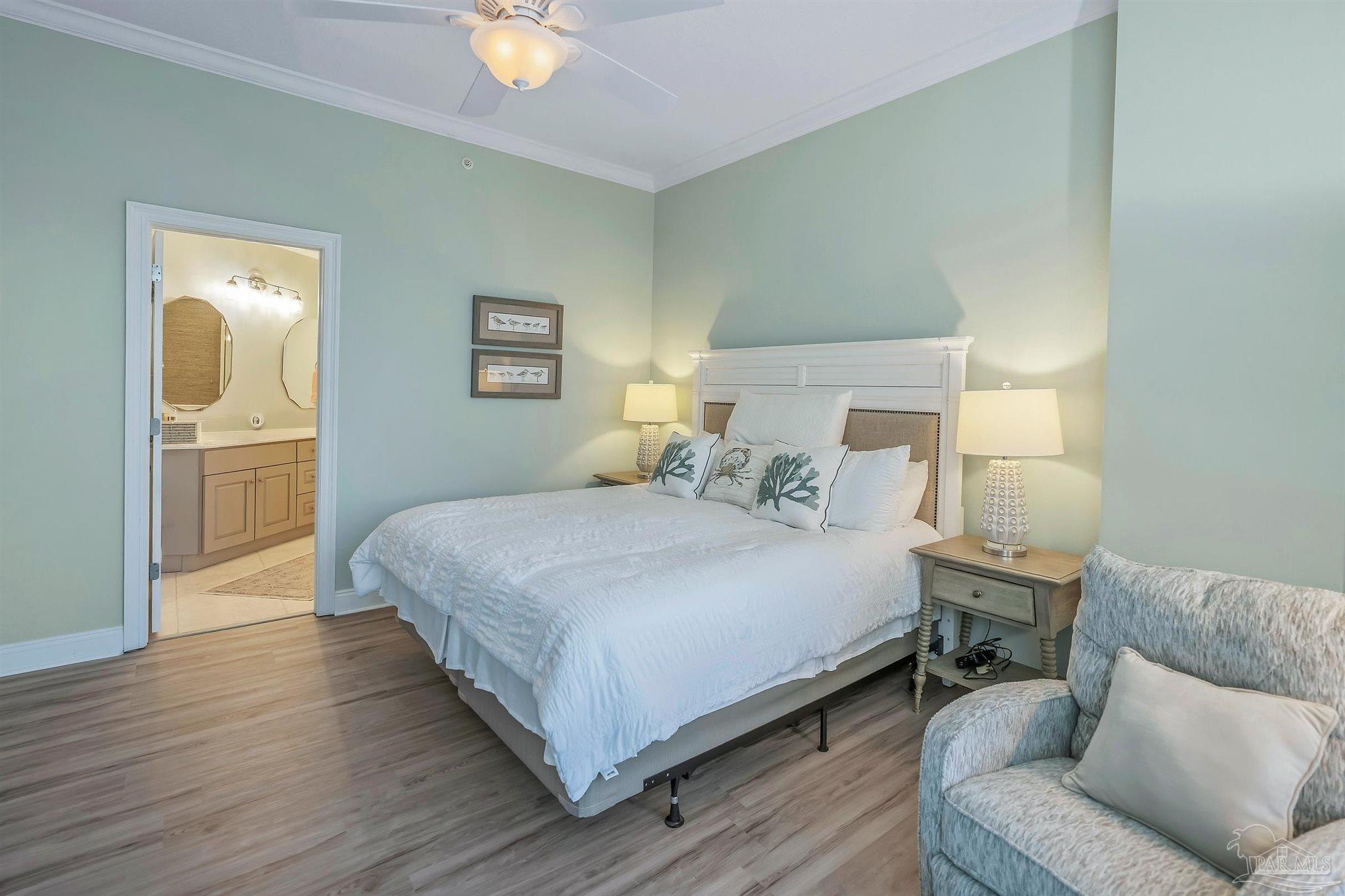 28250 Canal Road, Unit 205 Orange Beach, AL 36561 - Photo 28 of 60 a bedroom with a bed and wooden floor