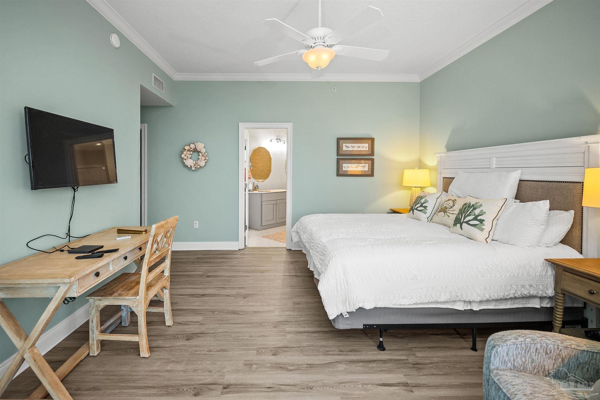 28250 Canal Road, Unit 205 Orange Beach, AL 36561 - Photo 29 of 60 a bedroom with a bed and a flat screen tv