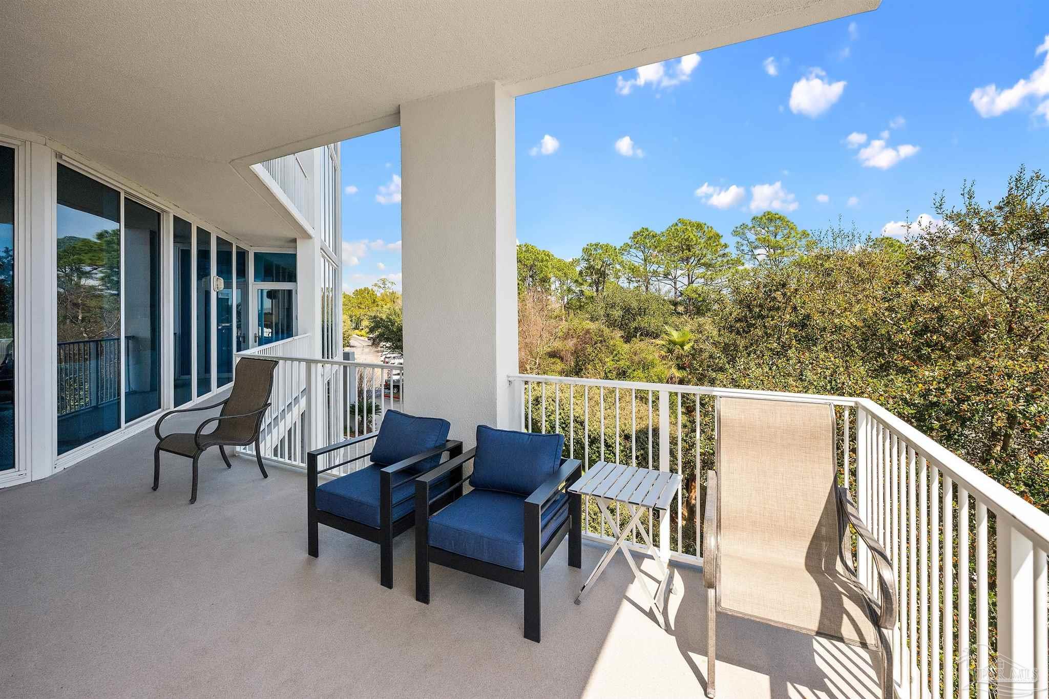 28250 Canal Road, Unit 205 Orange Beach, AL 36561 - Photo 33 of 60 a balcony with furniture and a yard